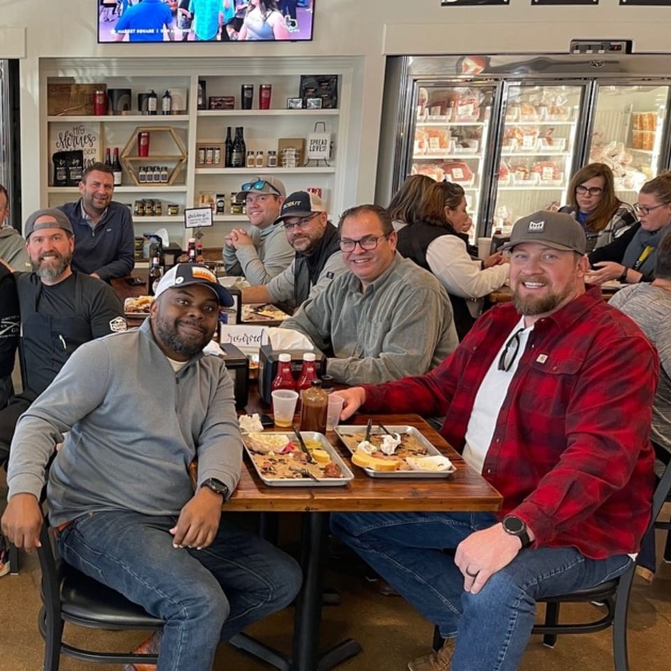 Customers enjoying meals at Flurry’s Market Lakeside, with deli refrigerators visible in the background.